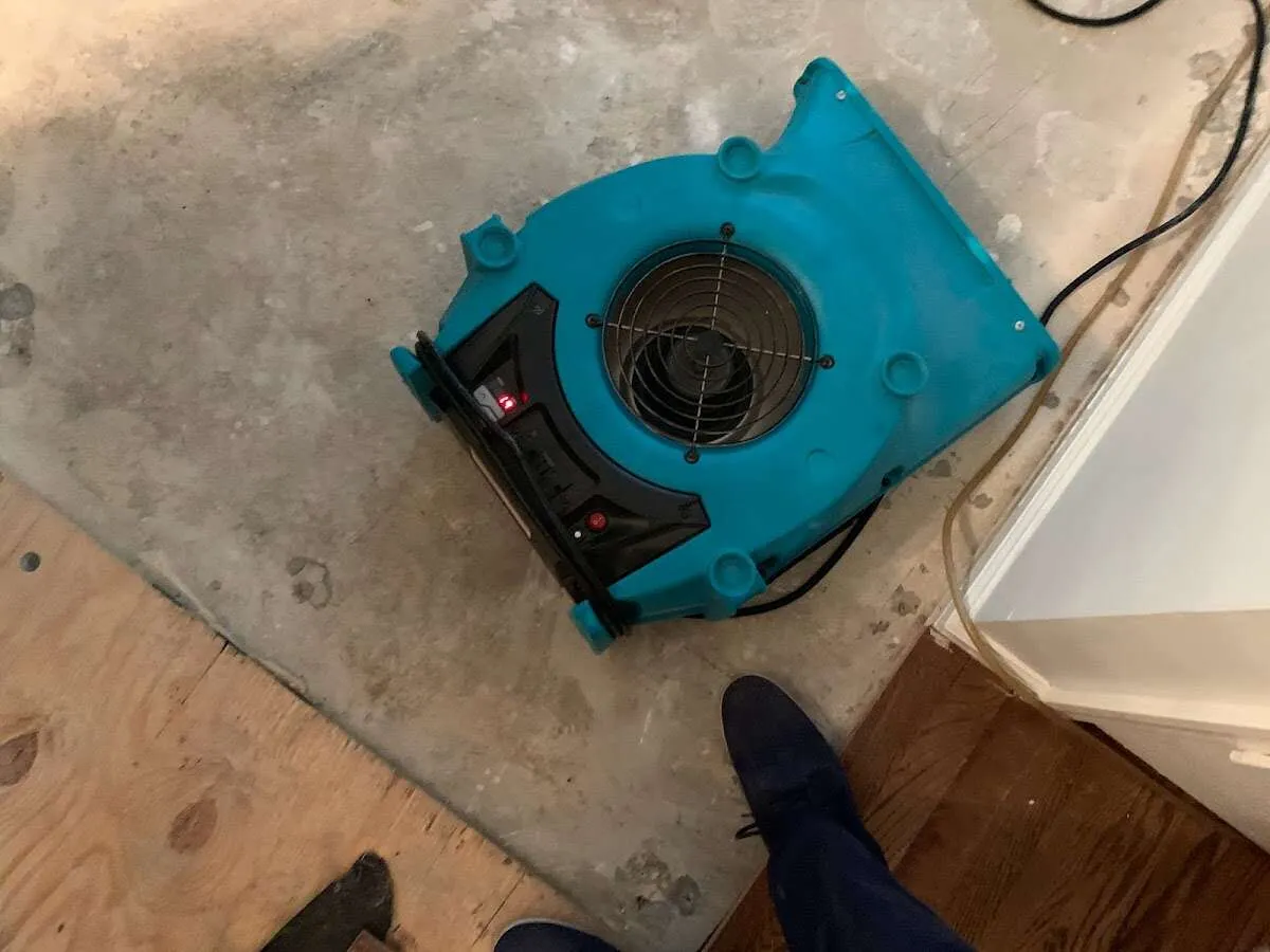 Air mover drying subfloor during Commercial Water Damage Restoration in Spout Springs